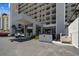 Condominium entrance featuring covered parking, pristine landscaping, and convenient building access at 15462 Gulf Blvd # 504, Madeira Beach, FL 33708