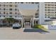 Entrance of condominium building featuring covered parking, immaculate landscaping, and convenient access at 15462 Gulf Blvd # 504, Madeira Beach, FL 33708