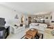 Cozy living room featuring comfortable sofas and an open layout that connects to the dining area at 15462 Gulf Blvd # 504, Madeira Beach, FL 33708