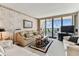 Comfortable living room featuring a waterfront view and plush seating with a beige color palette at 15462 Gulf Blvd # 504, Madeira Beach, FL 33708