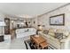 Comfortable living room featuring couches and art, seamlessly flowing into an open-concept kitchen and dining area at 15462 Gulf Blvd # 504, Madeira Beach, FL 33708
