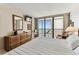 The bright main bedroom has a serene balcony view and comfortable seating at 15462 Gulf Blvd # 504, Madeira Beach, FL 33708