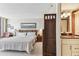 Bright main bedroom with a wooden headboard, ensuite bathroom, and a large picture window at 15462 Gulf Blvd # 504, Madeira Beach, FL 33708