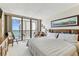 This spacious main bedroom offers a balcony with scenic views and comfortable seating at 15462 Gulf Blvd # 504, Madeira Beach, FL 33708