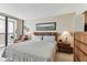Comfortable main bedroom with a balcony and ample natural light at 15462 Gulf Blvd # 504, Madeira Beach, FL 33708