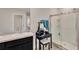 Bathroom showcasing vanity with sink, mirror, makeup table, and glass-enclosed shower at 16149 Tuscany Hillside Rd, Odessa, FL 33556