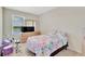 Bright bedroom featuring a drum set, large window, and light wood dresser at 16149 Tuscany Hillside Rd, Odessa, FL 33556