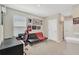 Bonus room features a futon, desk, and gaming chair with a window for natural light at 16149 Tuscany Hillside Rd, Odessa, FL 33556