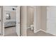 Hallway view with a bathroom and bedroom, showcasing the home's layout at 16149 Tuscany Hillside Rd, Odessa, FL 33556