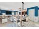 Open-concept living and dining area featuring a kitchen, an island dining table, and comfortable seating at 16149 Tuscany Hillside Rd, Odessa, FL 33556