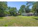 Expansive backyard with a wooden fence, mature trees, and room for outdoor living and play at 186 Grand Ave, Brooksville, FL 34604
