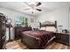 Bedroom featuring a striking wooden bed frame, wooden floors and a sunlit window enhancing the cozy atmosphere at 186 Grand Ave, Brooksville, FL 34604