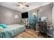 Cozy bedroom with a TV, wooden floors, and contemporary decor at 186 Grand Ave, Brooksville, FL 34604