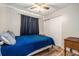 Bedroom features a blue comforter, dark curtains, and wood-look flooring at 186 Grand Ave, Brooksville, FL 34604