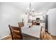 Dining area featuring hardwood floors, white walls, and a view into the well-lit kitchen at 186 Grand Ave, Brooksville, FL 34604