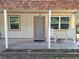 Charming covered front porch with rocking chairs, creating a cozy and welcoming entrance to the home at 186 Grand Ave, Brooksville, FL 34604