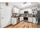 Well-appointed kitchen featuring stainless steel appliances and white cabinets at 186 Grand Ave, Brooksville, FL 34604