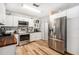 Well-lit kitchen with stainless steel appliances, wood countertops, and updated flooring for a modern appeal at 186 Grand Ave, Brooksville, FL 34604