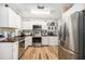 Bright kitchen featuring stainless steel appliances, white cabinetry, and butcher block countertops at 186 Grand Ave, Brooksville, FL 34604
