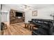 Inviting living room with a wood accent wall, a large television, and comfortable leather seating at 186 Grand Ave, Brooksville, FL 34604