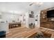 Open-concept living and dining area featuring hardwood floors and a rustic wood accent wall at 186 Grand Ave, Brooksville, FL 34604