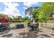 A view of the backyard deck with an outdoor dining set and a white railing at 1905 Mckinley St, Clearwater, FL 33765