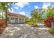 Backyard area with seating and paver drive leading to a garage at 1905 Mckinley St, Clearwater, FL 33765