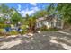 Exterior view of a well landscaped home with a backyard seating area at 1905 Mckinley St, Clearwater, FL 33765