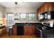 Well-appointed kitchen featuring wood cabinets, black countertops, and modern appliances, offering a functional and stylish space at 1905 Mckinley St, Clearwater, FL 33765