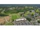 Aerial shot showcases community, golf course, clubhouse, parking, ponds, and lush greenery at 2113 Golf Manor Blvd, Valrico, FL 33596