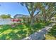 Beautiful backyard showcasing a screened-in pool with lush landscaping and a privacy fence at 2113 Golf Manor Blvd, Valrico, FL 33596