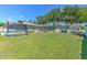 A large backyard features green grass, a trampoline, a screened-in pool and a white privacy fence at 2113 Golf Manor Blvd, Valrico, FL 33596