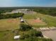 Aerial view of local baseball fields and school parking area filled with school buses at 2113 Golf Manor Blvd, Valrico, FL 33596