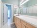 Bathroom featuring a long vanity and sink, walk in shower and closet access at 2113 Golf Manor Blvd, Valrico, FL 33596