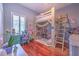 Charming bedroom features a wooden loft bed, playful decor, a study desk, and hardwood floors at 2113 Golf Manor Blvd, Valrico, FL 33596