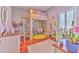 Bright bedroom showcasing a charming loft bed, workspace, hardwood floors, and natural light at 2113 Golf Manor Blvd, Valrico, FL 33596