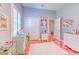 Light-filled bedroom with hardwood floors, plantation shutters, and playful decorations on display at 2113 Golf Manor Blvd, Valrico, FL 33596
