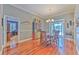 Bright dining room showcasing hardwood floors, chandelier, and views of the pool at 2113 Golf Manor Blvd, Valrico, FL 33596