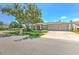 Inviting home featuring a spacious driveway, three-car garage, and landscaped front yard at 2113 Golf Manor Blvd, Valrico, FL 33596