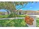 A home's picturesque exterior view showcases mature trees and lush landscaping at 2113 Golf Manor Blvd, Valrico, FL 33596