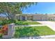 Charming single-story home featuring a well-manicured lawn and a three-car garage at 2113 Golf Manor Blvd, Valrico, FL 33596