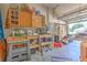 View of garage with work bench, storage cabinets, tools, and other equipment at 2113 Golf Manor Blvd, Valrico, FL 33596