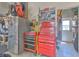 View of garage with tool boxes, tools, and a refrigerator at 2113 Golf Manor Blvd, Valrico, FL 33596