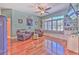 Comfortable living room featuring hardwood floors, built-in shelves, and a window seat at 2113 Golf Manor Blvd, Valrico, FL 33596