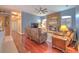 Comfortable living room with stone fireplace, hardwood flooring, and ceiling fan at 2113 Golf Manor Blvd, Valrico, FL 33596