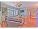 Cozy living room offering hardwood floors, built-in bookshelves, and ample natural light at 2113 Golf Manor Blvd, Valrico, FL 33596