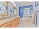 Large main bathroom with double sinks, soaking tub, and tiled floor at 2113 Golf Manor Blvd, Valrico, FL 33596