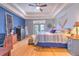Spacious main bedroom featuring a ceiling fan, wood floors, and access to a pool view at 2113 Golf Manor Blvd, Valrico, FL 33596