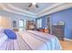 Spacious main bedroom has a tray ceiling and is decorated in relaxing colors at 2113 Golf Manor Blvd, Valrico, FL 33596