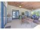Relaxing screened patio with wood ceilings, ceiling fans, TV, outdoor grill, and comfortable seating at 2113 Golf Manor Blvd, Valrico, FL 33596